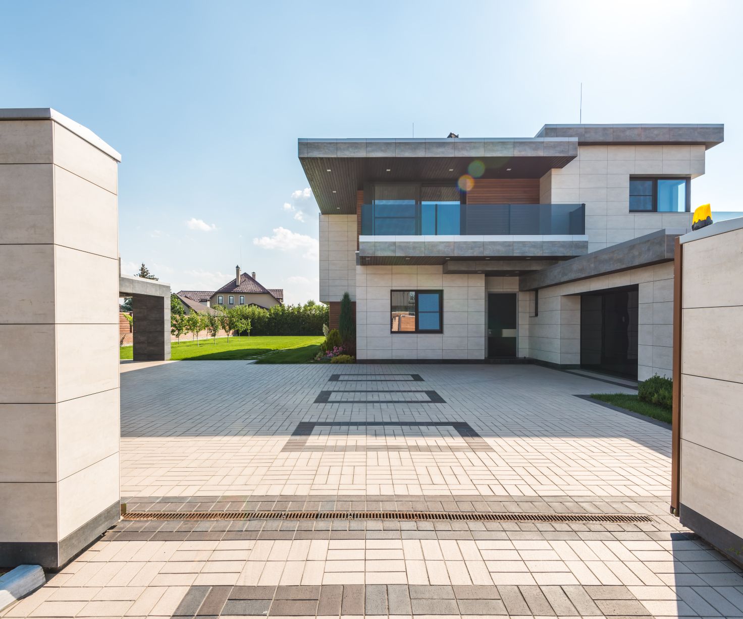 A clean, freshly powerwashed driveway in front of a modern home